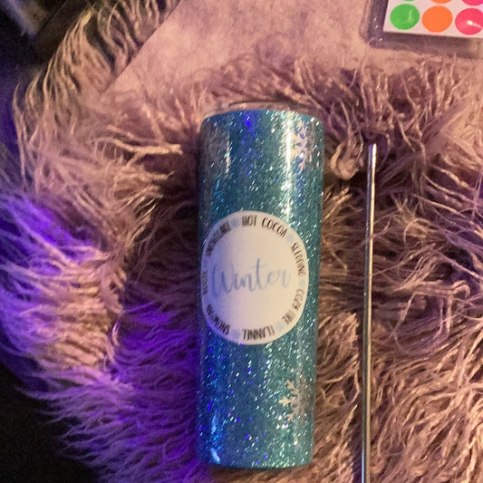 20 oz tumbler with icy blue glitter, snowflake accents, and cozy winter-themed decal; includes lid and straw