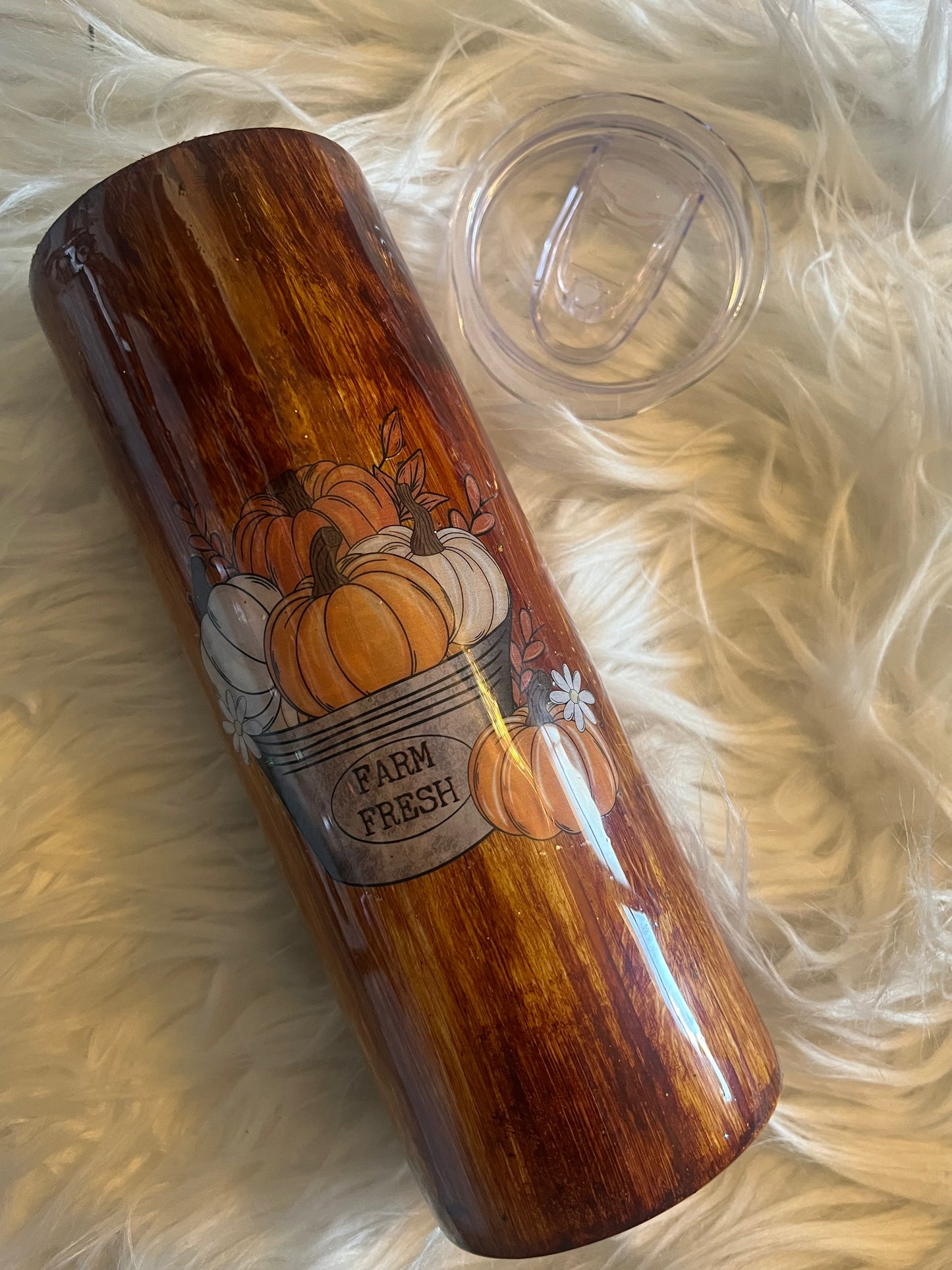 20 oz Farm Fresh pumpkin tumbler with woodgrain finish, includes lid and straw, photographed on cream faux fur
