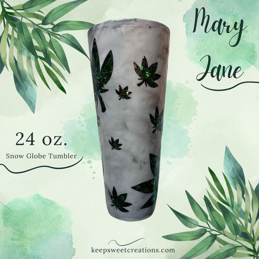 A promotional image featuring a 24 oz. snow globe tumbler with a white frosted finish, decorated with green cannabis leaves and a pink glitter effect.
