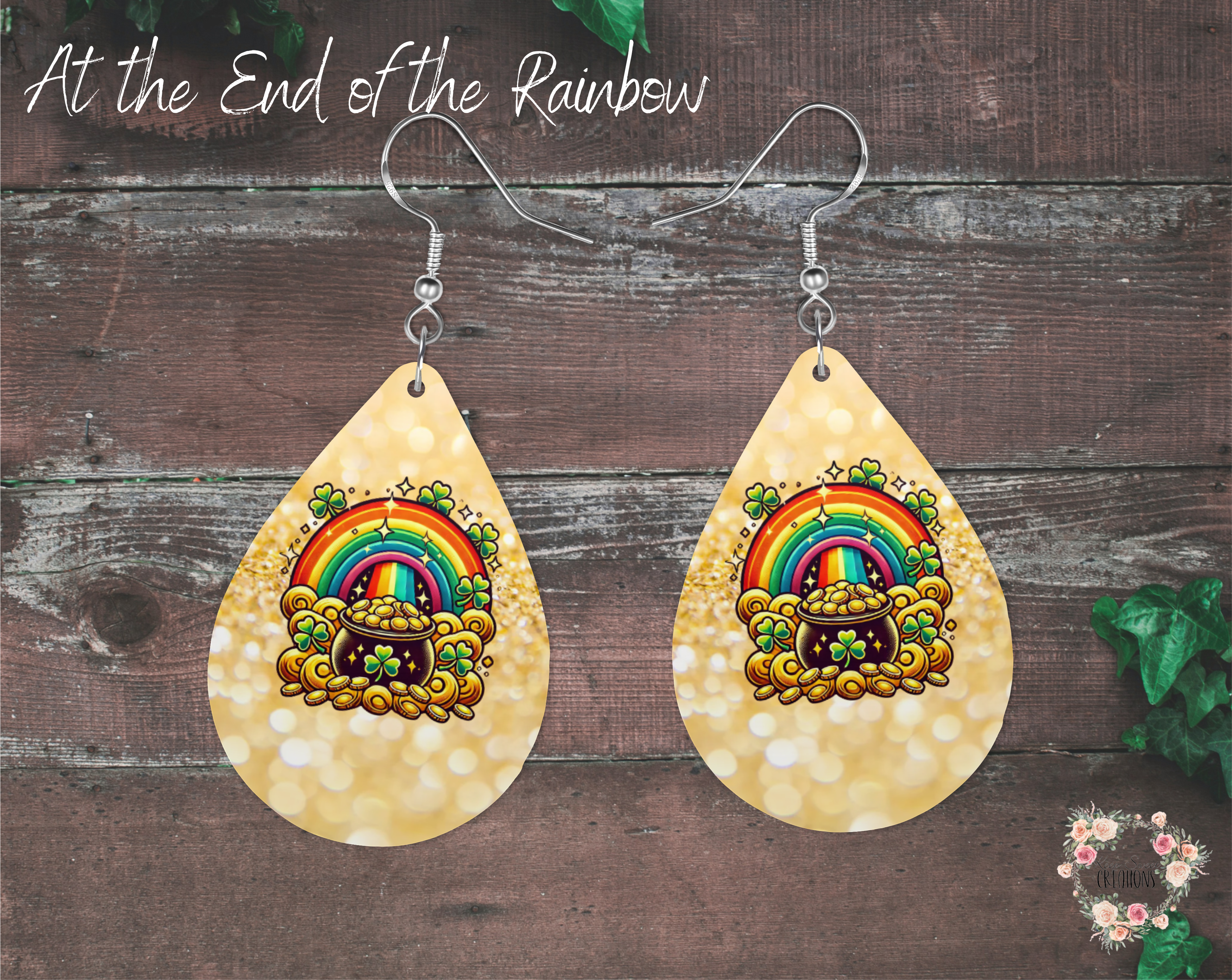"A pair of teardrop-shaped St. Patrick’s Day earrings featuring a pot of gold at the end of a vibrant rainbow, surrounded by shamrocks and gold coins. The background is a shimmering gold effect. These festive earrings are made from lightweight sublimation wood with nickel-free hypoallergenic hooks, perfect for celebrating Irish luck and style."