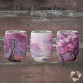 cherry blossom themed tumblers with a pink and purple artistic design.