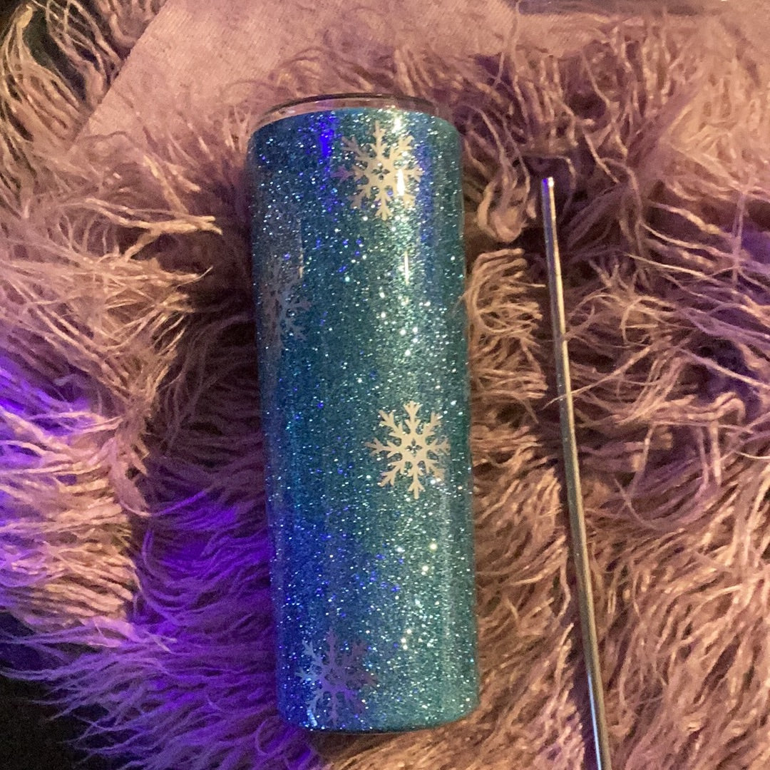 20 oz tumbler with icy blue glitter, snowflake accents, and cozy winter-themed decal; includes lid and straw