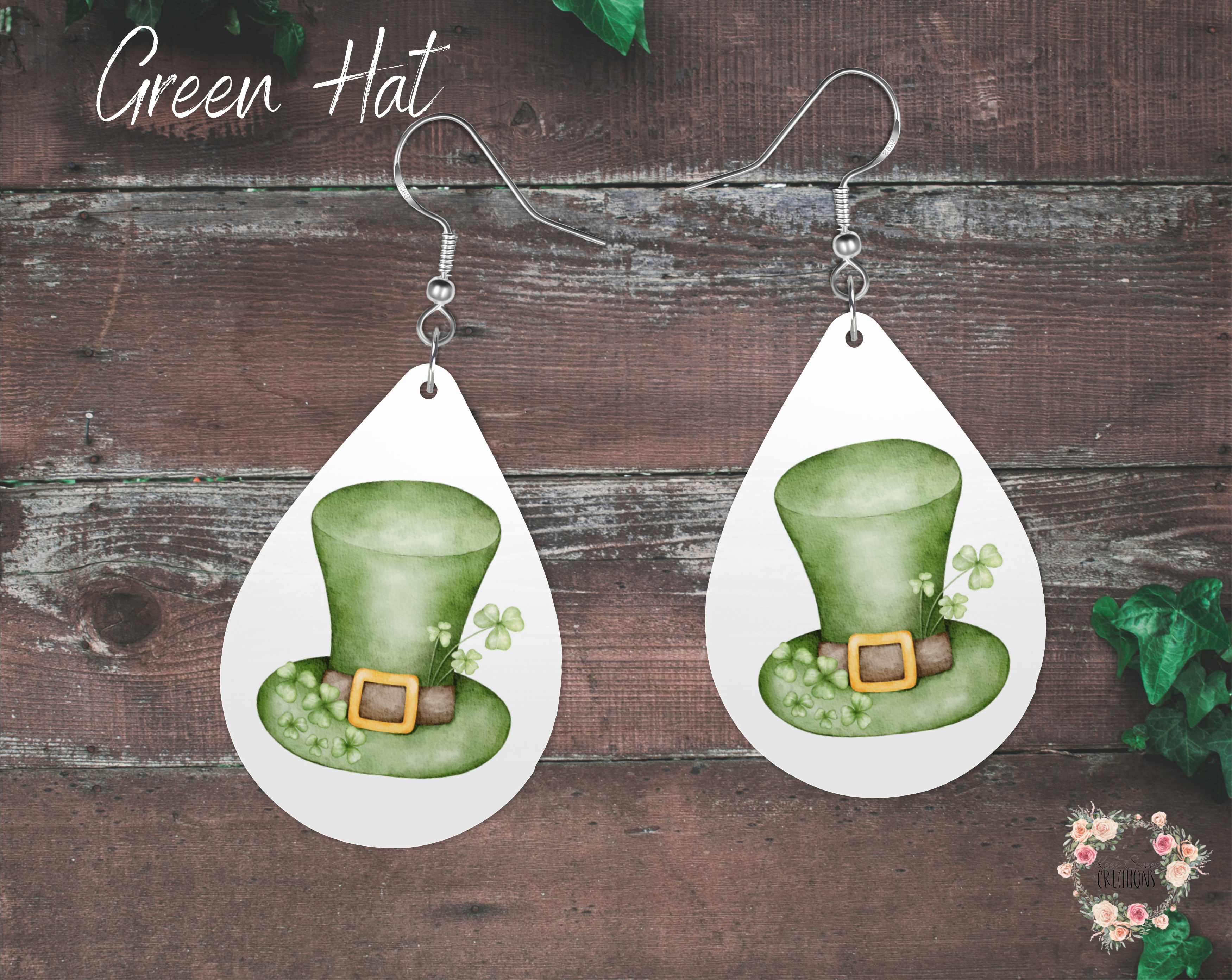 "A pair of teardrop-shaped St. Patrick’s Day earrings featuring a watercolor-style green leprechaun hat with a gold buckle and small shamrocks on a white background. These lightweight sublimation wood earrings have nickel-free hypoallergenic hooks, making them a festive and stylish accessory for the holiday."