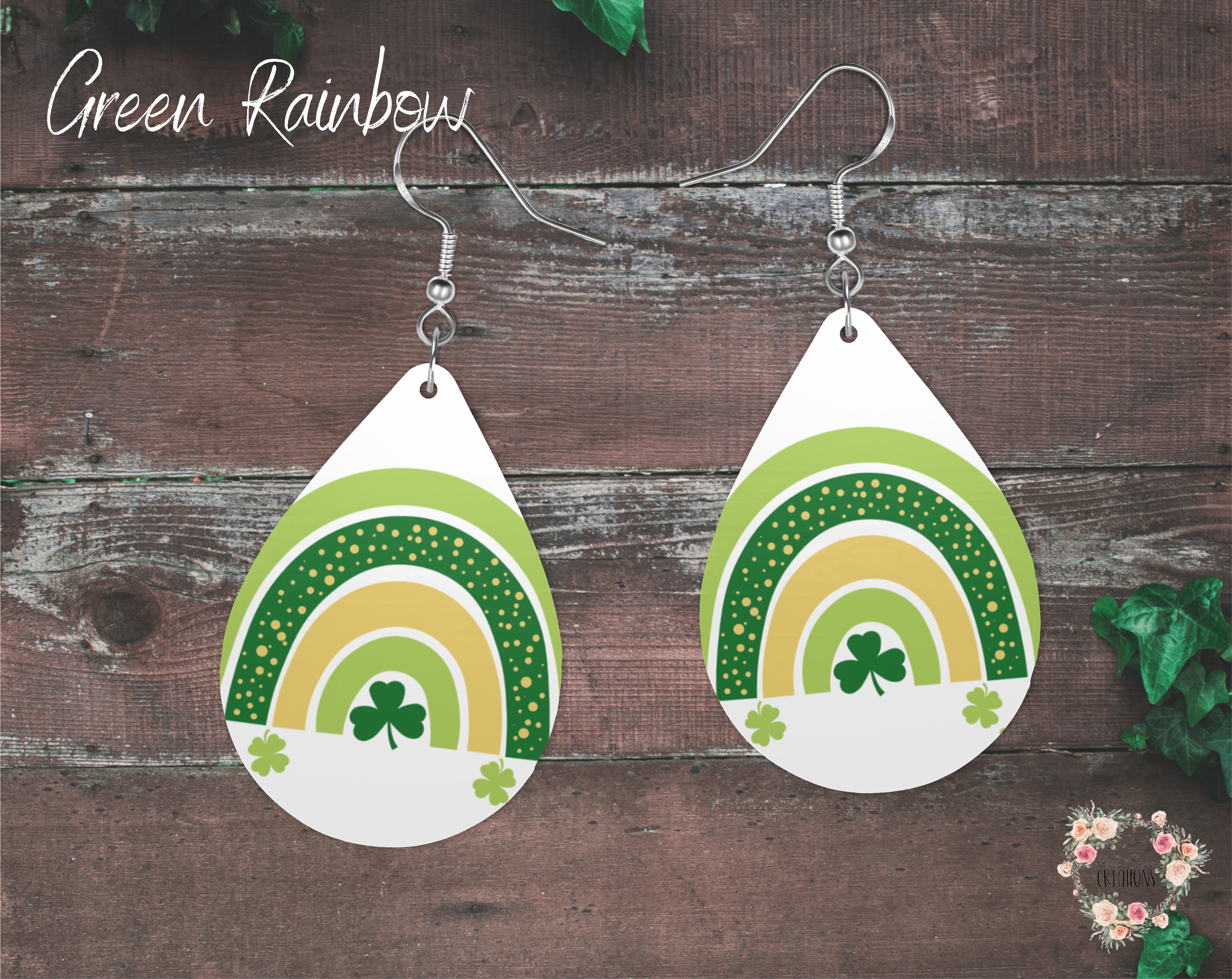 "A pair of teardrop-shaped St. Patrick’s Day earrings featuring a modern green and gold rainbow design with shamrocks on a white background. These lightweight sublimation wood earrings have nickel-free hypoallergenic hooks, making them a festive and stylish accessory for celebrating Irish heritage."