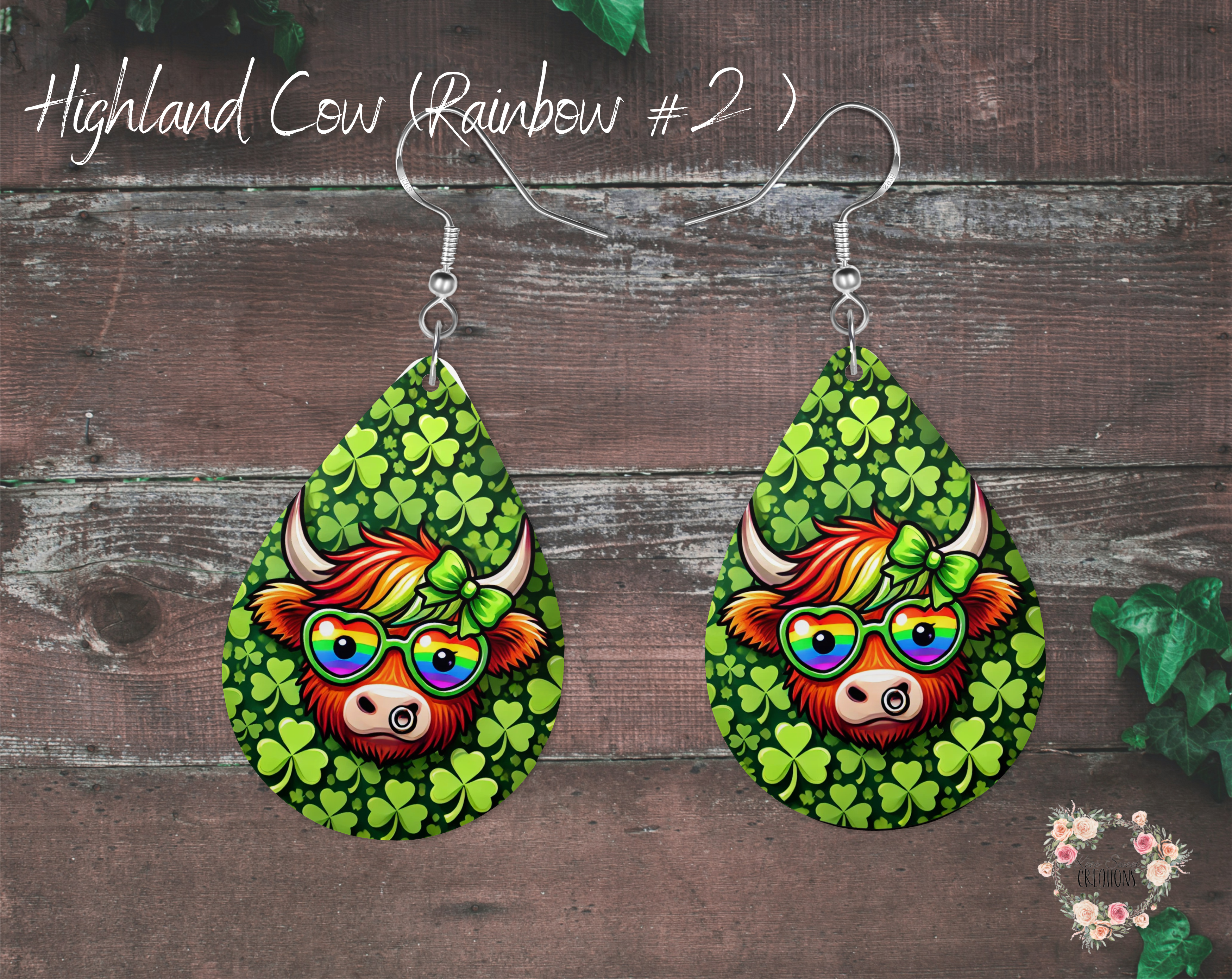 A pair of teardrop-shaped St. Patrick’s Day earrings featuring a Highland cow with rainbow glasses, a green polka-dot bow, and a shamrock-covered background. The earrings are made from lightweight sublimation wood with nickel-free hypoallergenic hooks, perfect for festive wear."