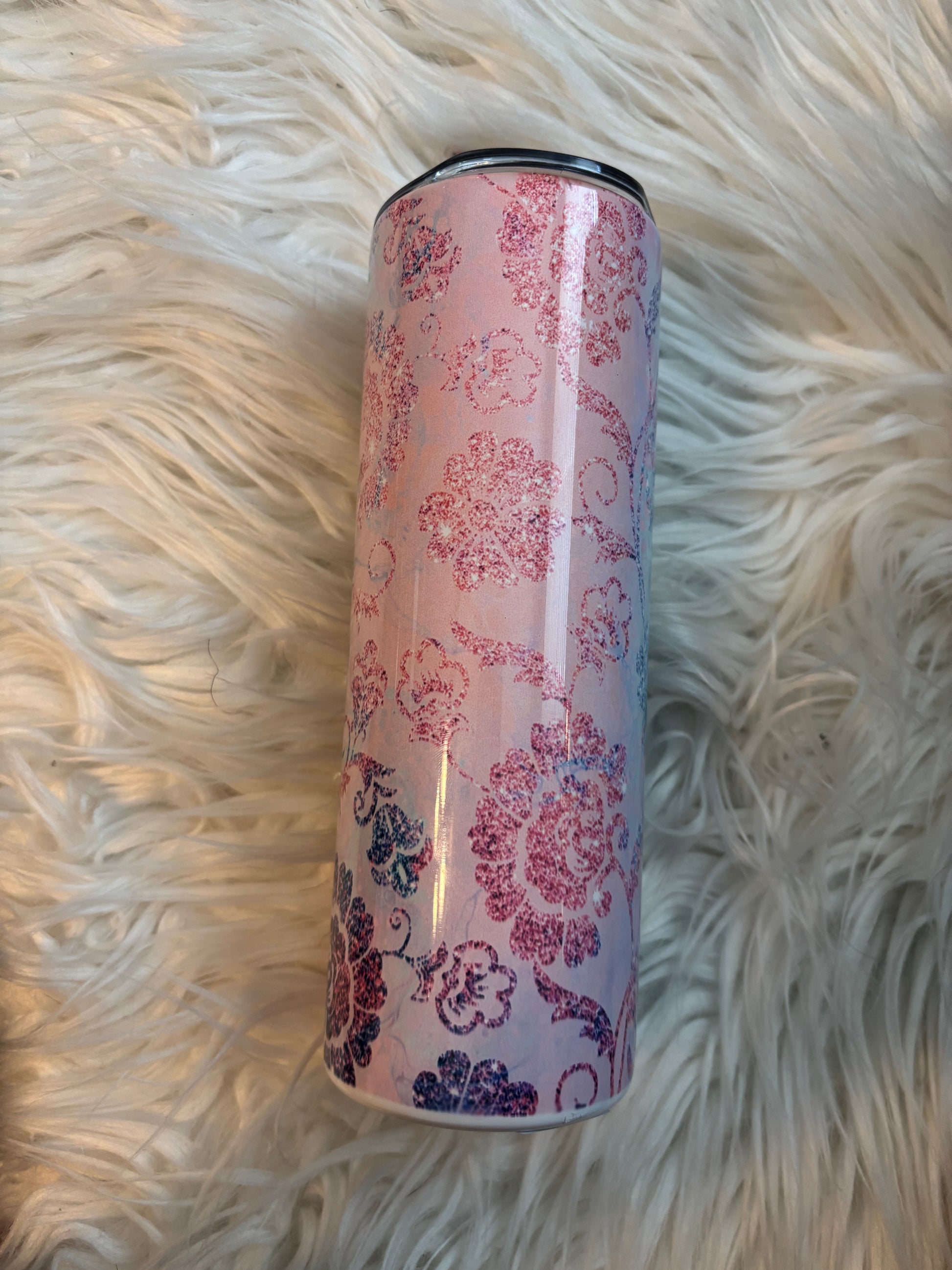 20 oz stainless steel tumbler with pink and blue floral sublimation design on a faux fur background