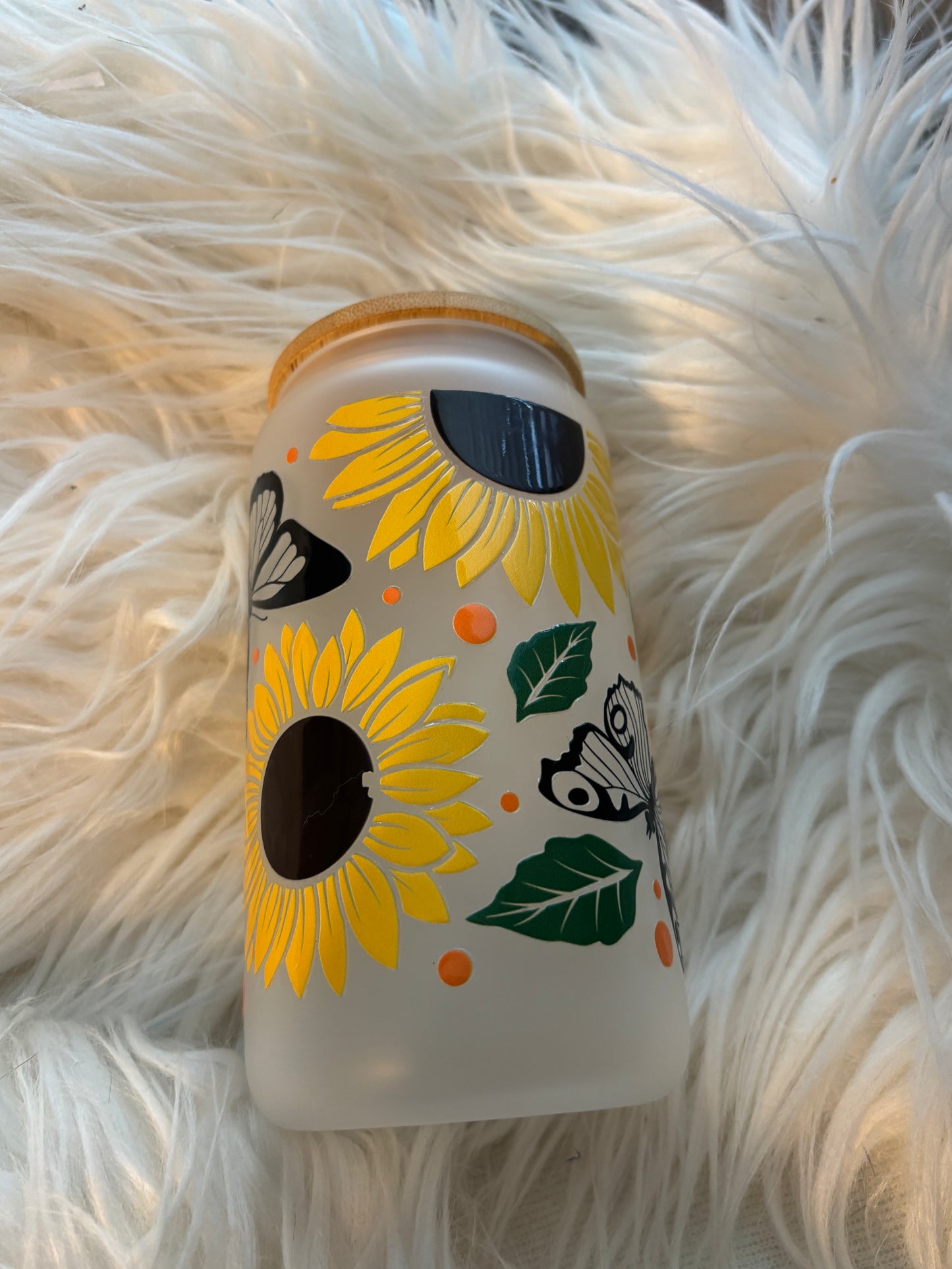 Side view of sunflower UVDTF decal showing butterflies and leaf detail on frosted tumbler