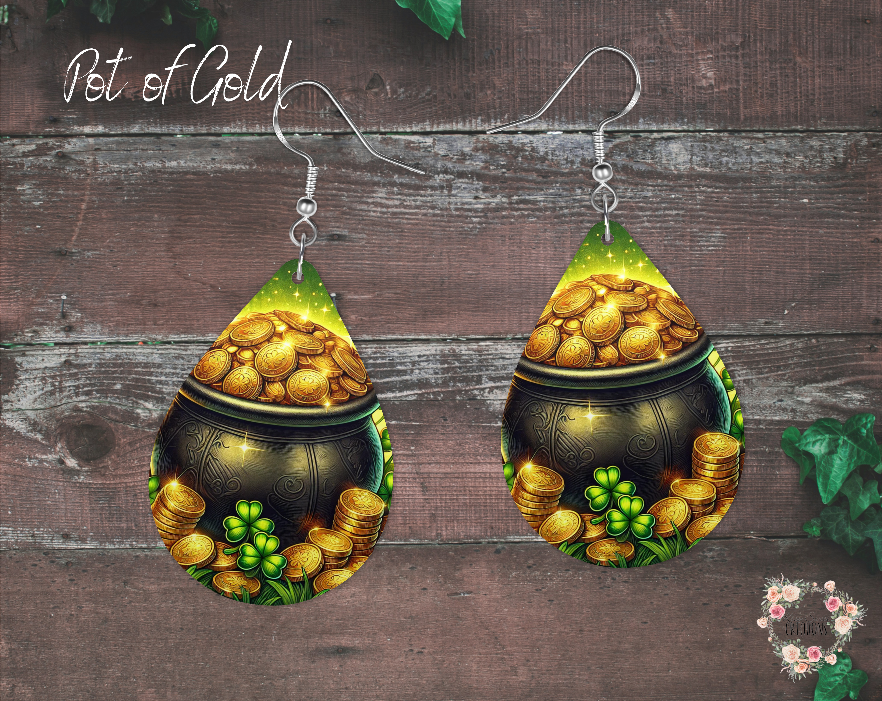 "A pair of teardrop-shaped St. Patrick’s Day earrings featuring a black cauldron overflowing with gold coins, surrounded by green shamrocks. The earrings have a glowing, magical background and are made from lightweight sublimation wood with nickel-free hypoallergenic hooks."
