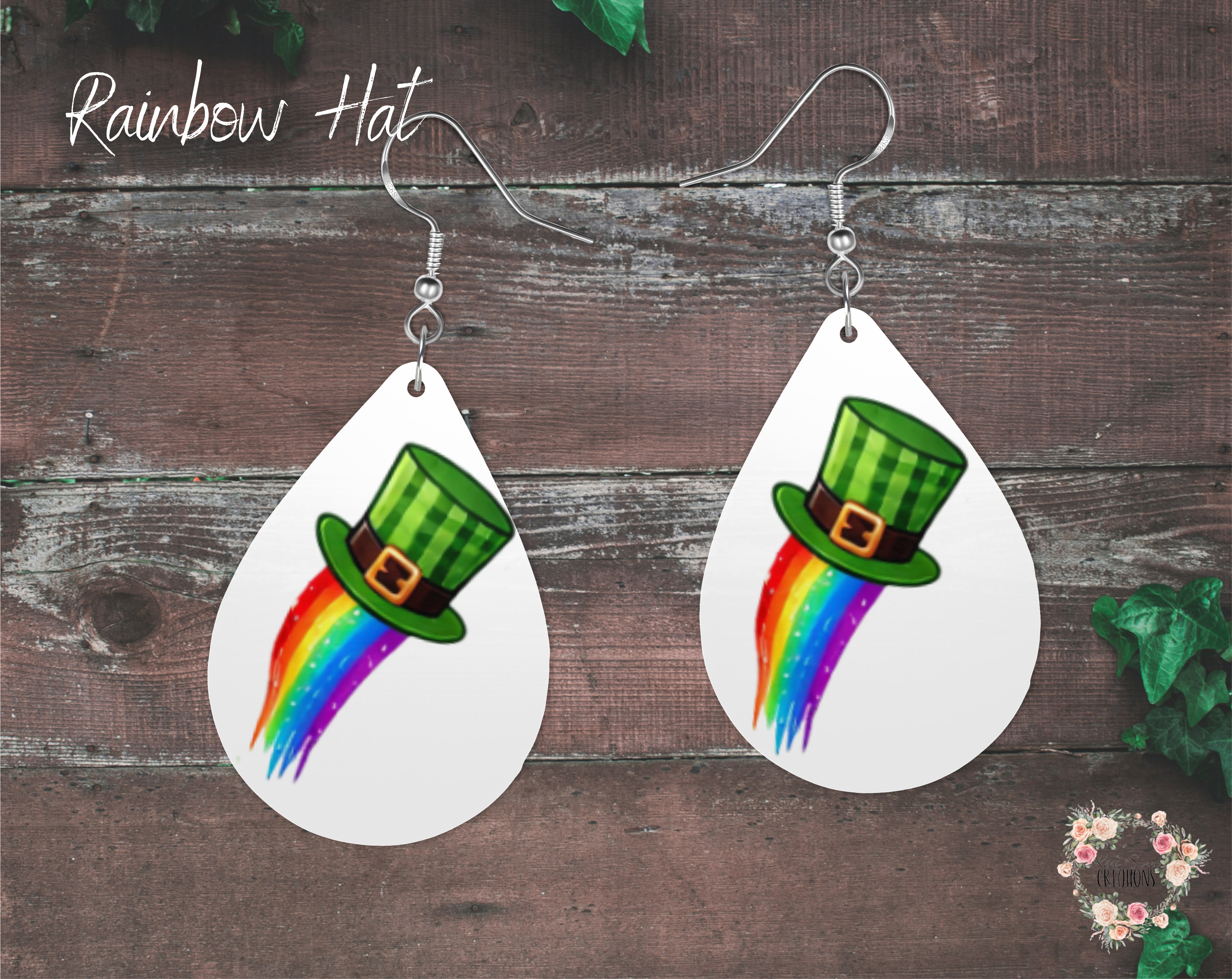 "A pair of teardrop-shaped St. Patrick’s Day earrings featuring a green plaid leprechaun hat with a vibrant rainbow trail extending downward. These festive earrings are made from lightweight sublimation wood with nickel-free hypoallergenic hooks, perfect for celebrating the holiday in style."
