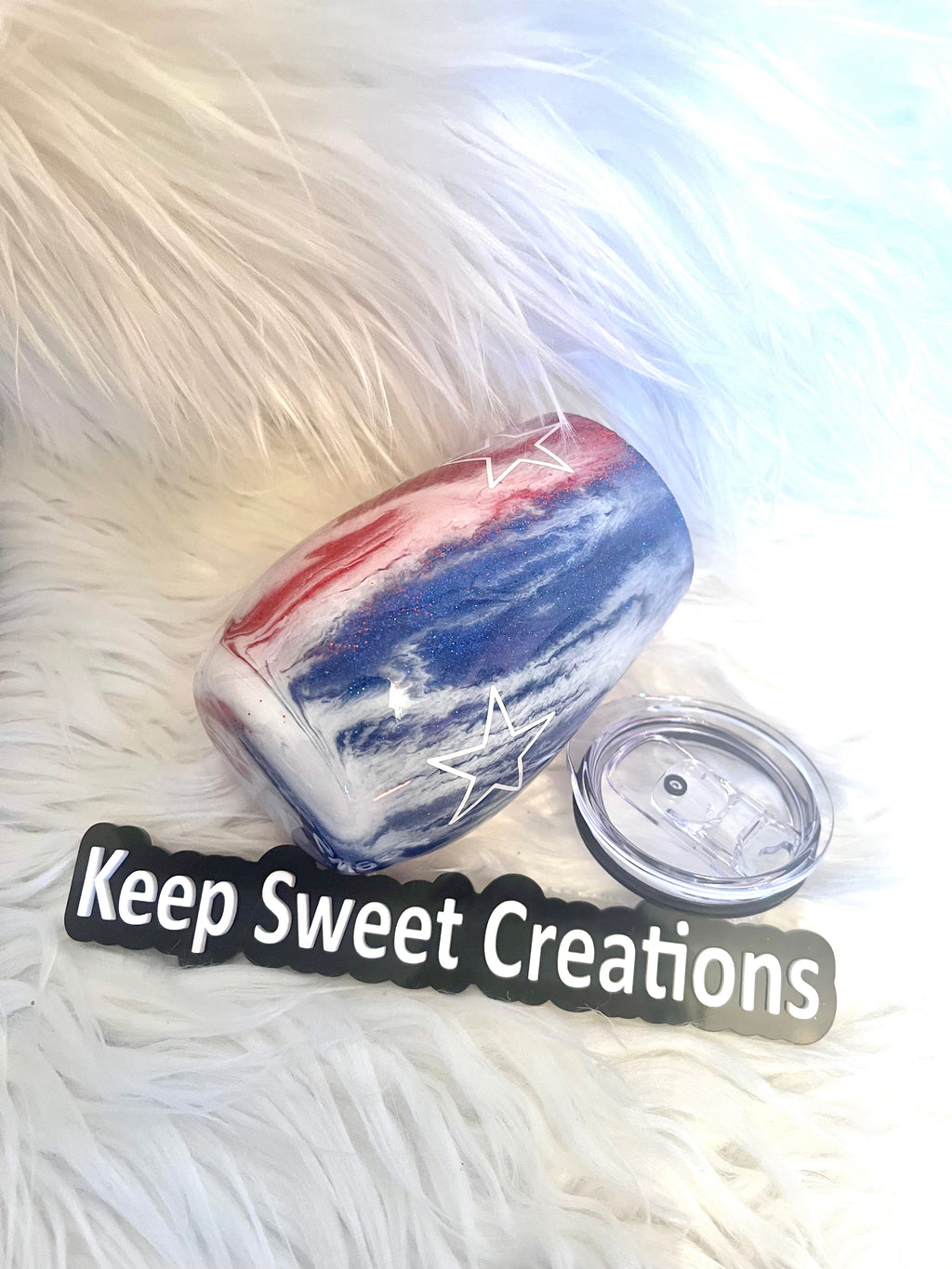 14 oz patriotic glitter tumbler with lid and straw on faux fur background