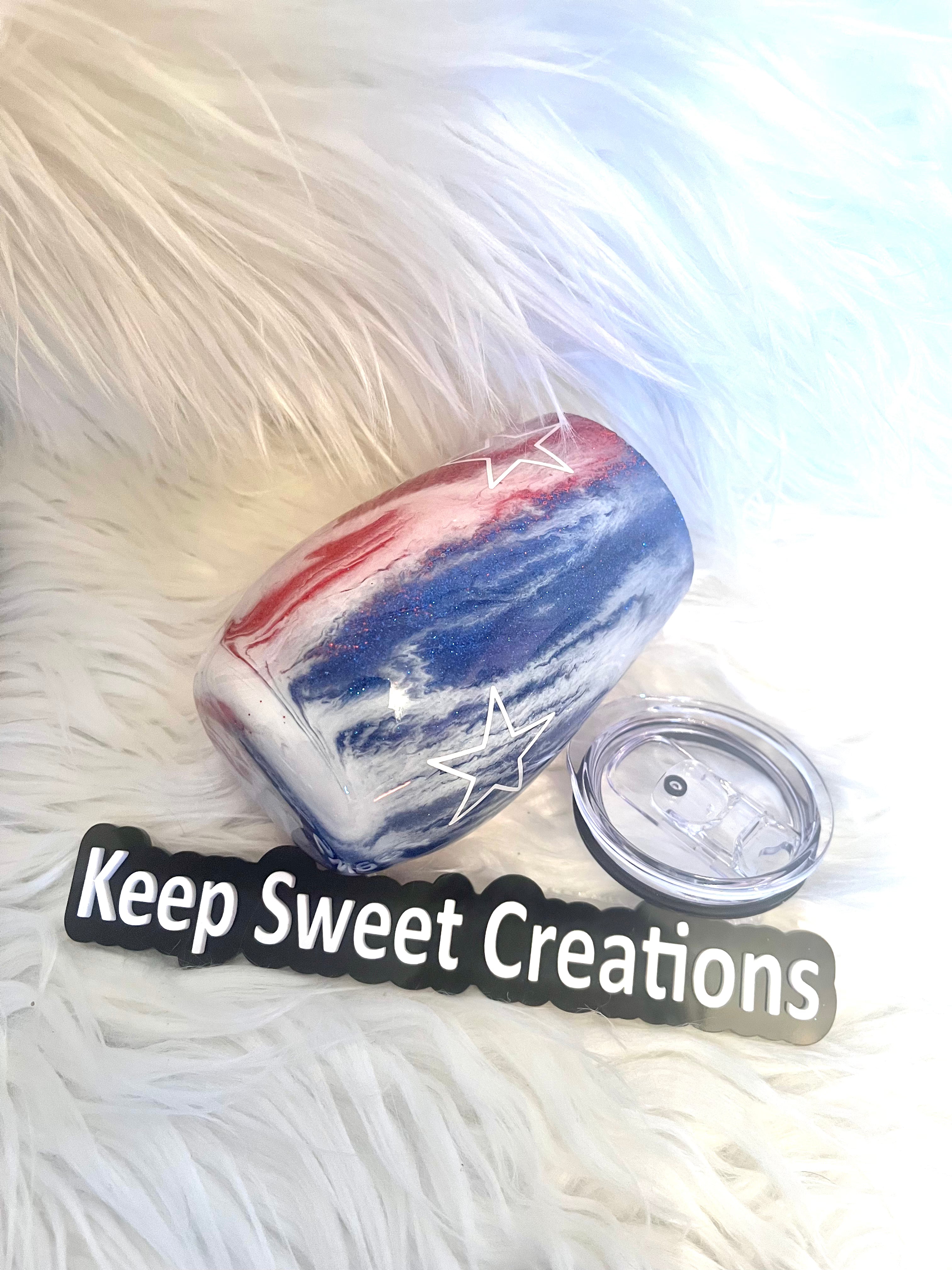14 oz patriotic glitter tumbler with lid and straw on faux fur background